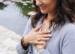 Woman holding her hands to her chest.
