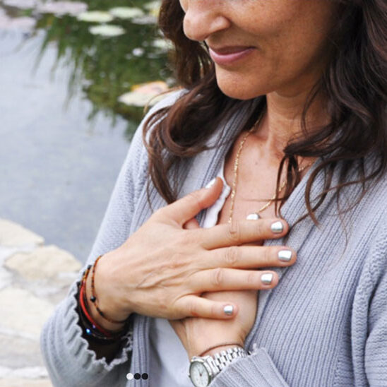 Woman holding her hands to her chest.