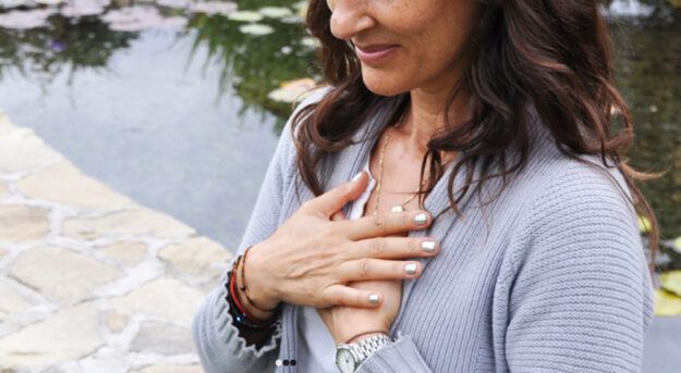 Woman holding her hands to her chest.